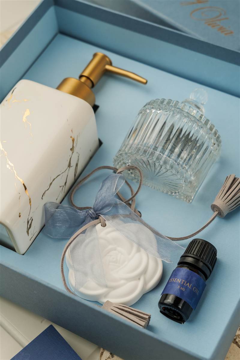 Marble soap dispenser, glass jar and essential oil in a blue gift box, Red Ribbon