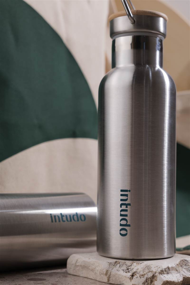Brushed steel tumbler on a stone block, Red Ribbon corporate gift