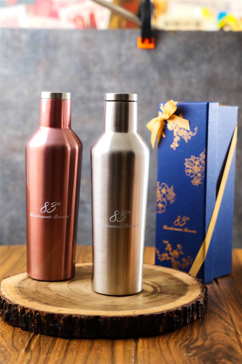 Rose gold and silver tumblers beside a navy gift box, Red Ribbon